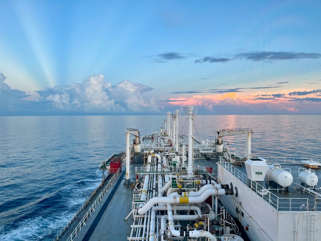 Tanker vessel sailing into the sunset