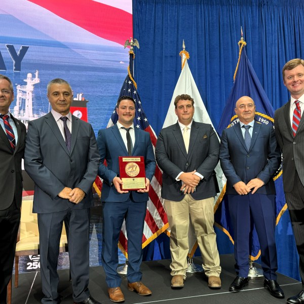 Stena Immaculate crew members, along with union and Crowley leadership, standing side by side with Gallant Ship Award plaque.