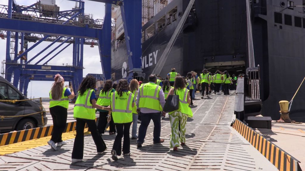 Students and visitors tour a Crowley cargo vessel, gaining firsthand exposure to maritime and logistics operations.